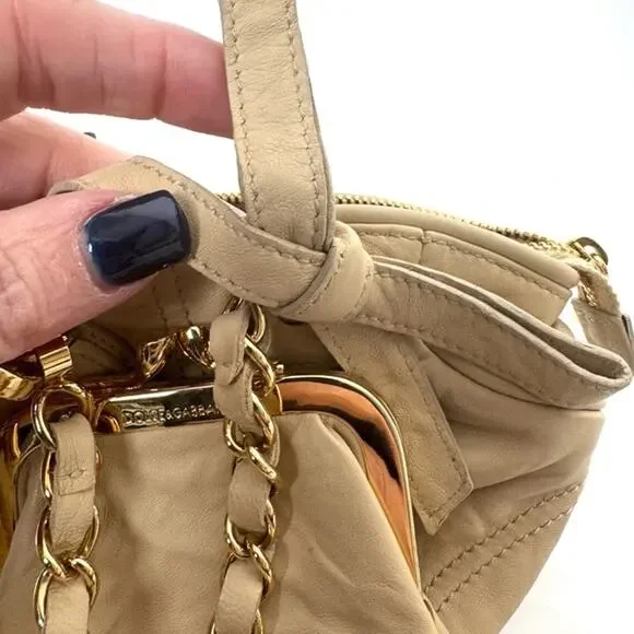 Dolce and Gabbana miniature leather bag with kiss lock, plaque and gold hardware